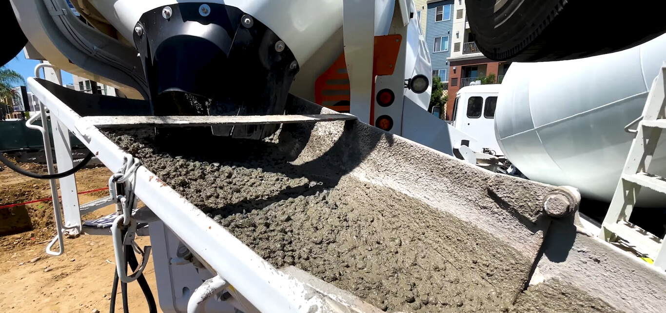 Professional concrete mixer truck pouring fresh concrete in Minot, ND